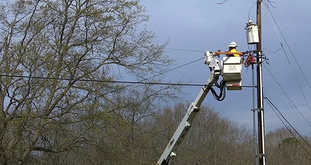 Utility worker near overhead power lines